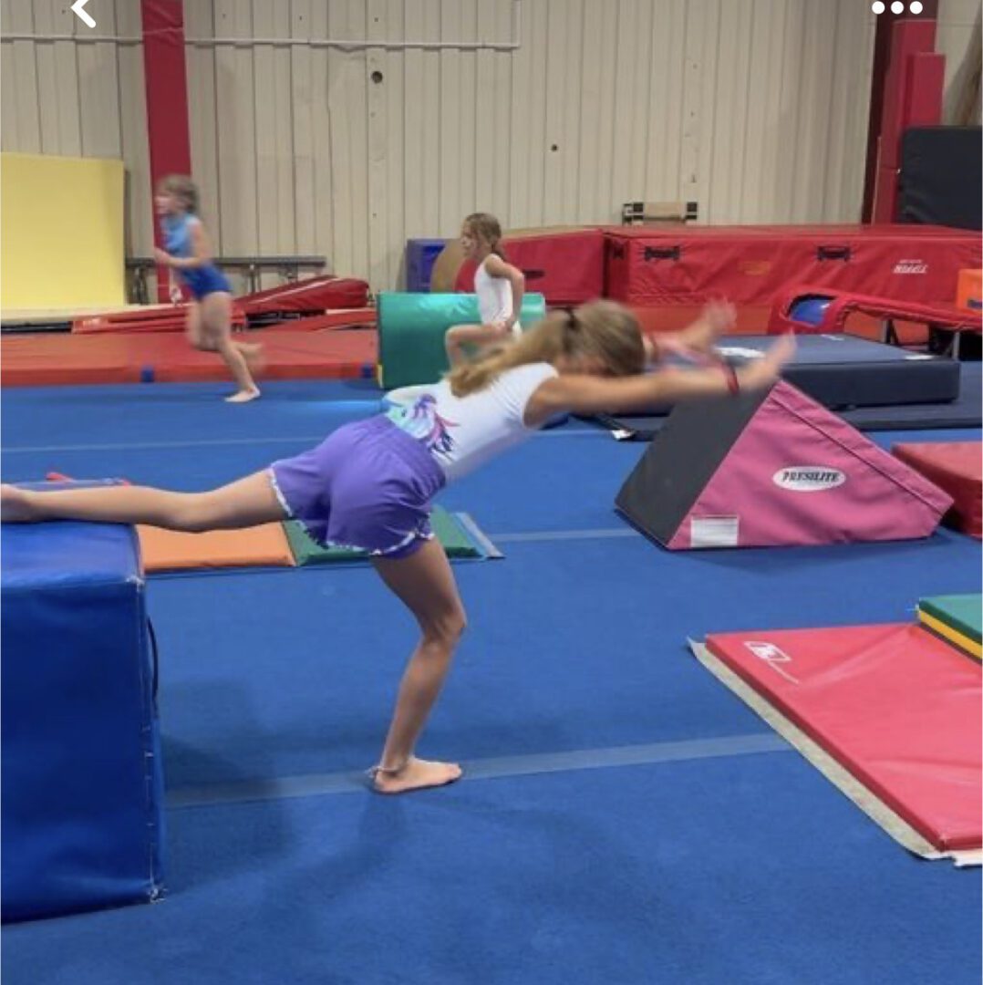 Some girls having a gymnastic exercise in a room