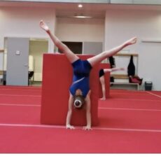 A girl doing gymnastic with legs in the air