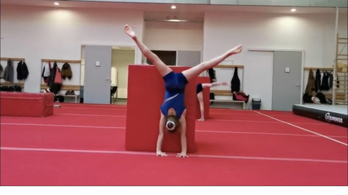 A girl doing gymnastic with legs in the air